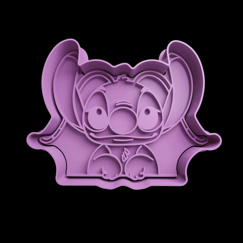 May include: Purple plastic cookie cutter shaped like Stitch from the Disney movie Lilo & Stitch. Stitch is shown with his signature blue eyes and a big smile.