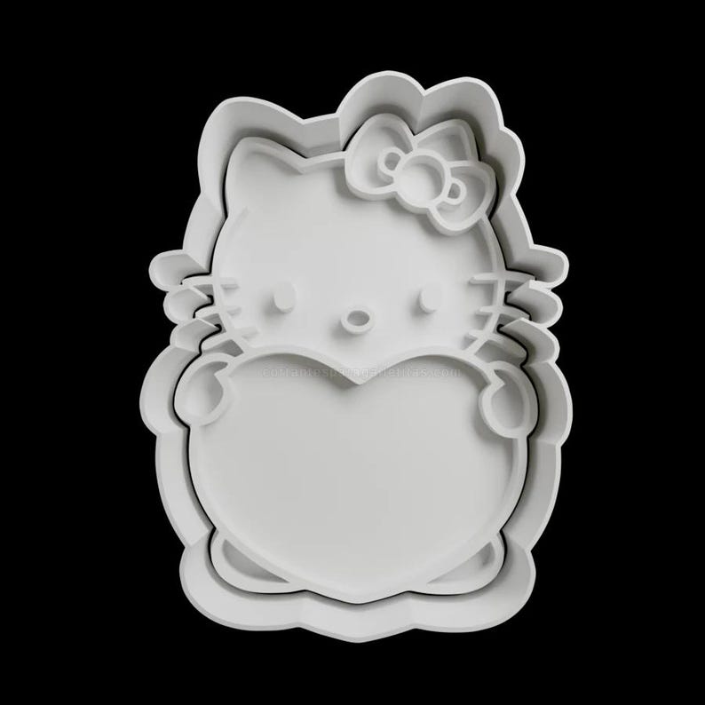 May include: White plastic cookie cutter shaped like a cartoon cat holding a heart. The cat has a bow on its head and a heart-shaped body.