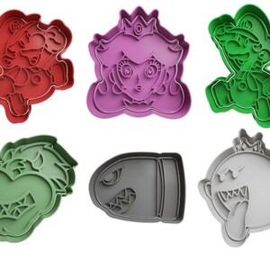 May include: Set of six cookie cutters featuring characters from the Super Mario Bros. video game franchise. The cutters are made of plastic and are in the shapes of Mario, Luigi, Princess Peach, Bowser, a Goomba, and a Bullet Bill. The cutters are red, green, purple, grey, and black.