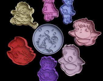 May include: Set of nine cookie cutters featuring characters from the animated film 'My Neighbor Totoro'. The cutters are made of light blue, pink, red, and gray plastic. The characters include Totoro, a girl with a cat, a girl with a basket, and a girl blowing bubbles.