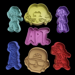 May include: Set of seven cookie cutters featuring cartoon characters and the word "APT". The cutters are in various colors, including blue, green, purple, red, and yellow.