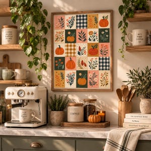 May include: A framed wall art print featuring a grid of twenty rectangular panels with autumn-themed illustrations of pumpkins, wildflowers, and navy blue gingham patterns in shades of orange, green, pink, and cream, displayed in a kitchen.