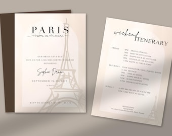 May include: Two-page invitation suite with a Parisian theme. The left page features the text "PARIS mon amour" and a stylized Eiffel Tower illustration. The right page is a weekend itinerary. The color scheme is neutral with a soft, beige background.
