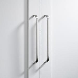 May include: Close-up of a white cabinet with two brushed nickel pull handles. The handles are long, curved, and vertically aligned, casting shadows on the cabinet doors. The cabinet doors are plain and white.