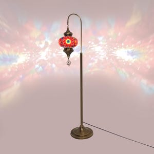 May include: A red and gold mosaic glass floor lamp with a curved arm and a round base. The lampshade is decorated with intricate geometric patterns.