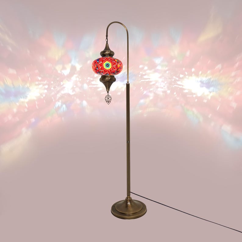 May include: A red and gold mosaic glass floor lamp with a curved arm and a round base. The lampshade is decorated with intricate geometric patterns.