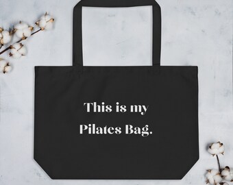May include: Black tote bag with white text that reads "This is my Pilates Bag."