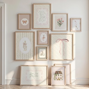 May include: A selection of framed art prints in a gentle pastel colour scheme. The prints depict a butterfly, a ballerina, a rabbit, a goose, tulips, a key, a house, and a pink bow. Some prints include text such as "Long Live Girlhood."