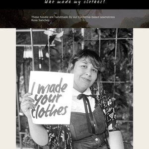 May include: A black and white photo of a woman holding a sign that says "I made your clothes".