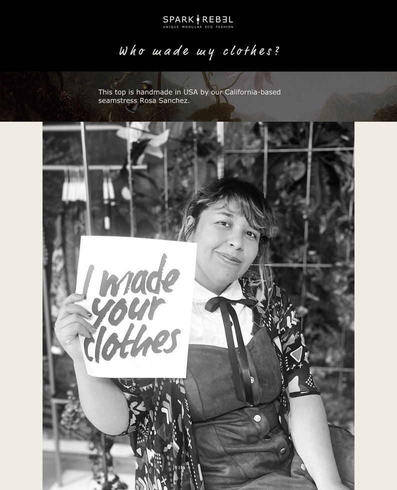 May include: A black and white photo of a woman holding a sign that says "I made your clothes". The woman is wearing a black and white patterned dress and a black bow.