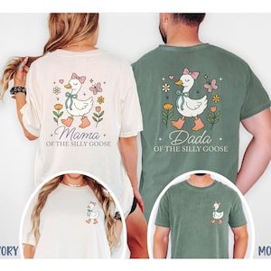 May include: Ivory and moss green t-shirts with a whimsical goose graphic. The ivory shirt features "Mama of the Silly Goose" and the moss green shirt says "Dada of the Silly Goose". A smaller goose graphic is on the front of the shirts.