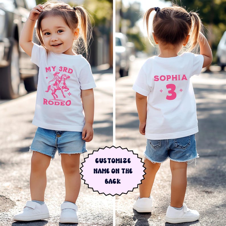 May include: White t-shirt with pink text and a graphic of a girl riding a horse. The front of the shirt says "My 3rd Rodeo". The back of the shirt says "Sophia 3".
