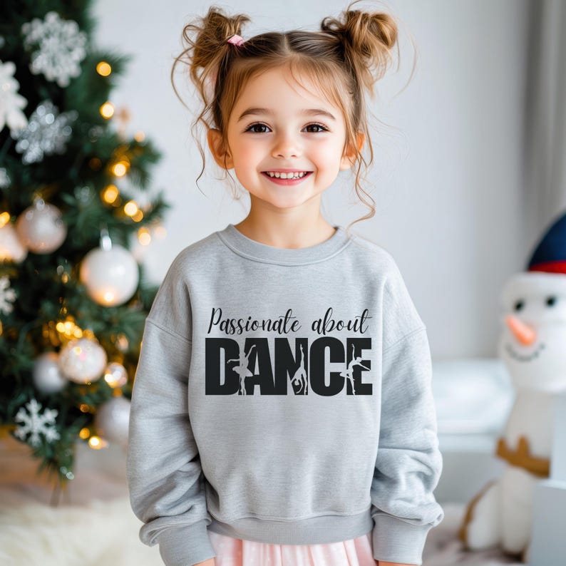 May include: A grey sweatshirt with the text "Passionate about DANCE" in black with a silhouette of dancers in the word "DANCE".