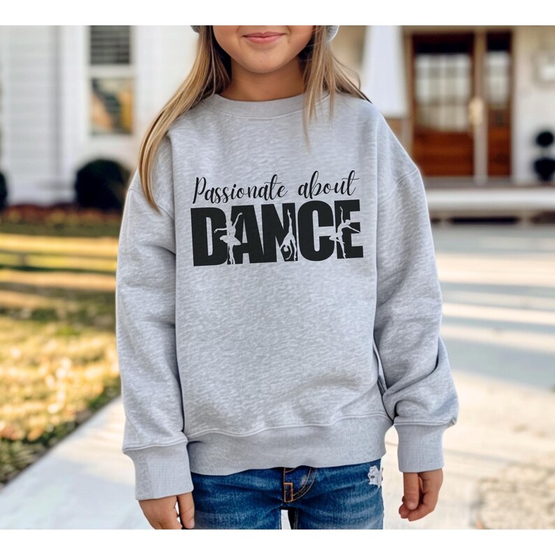 May include: A gray sweatshirt with the text "Passionate about DANCE" in black with a silhouette of dancers in the word "DANCE".