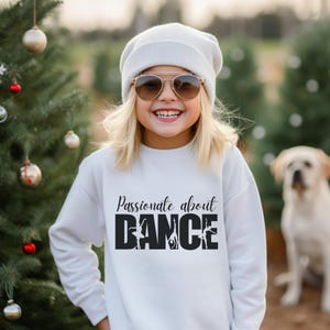 May include: A white sweatshirt with black text that reads "Passionate about DANCE" with a silhouette of dancers in the word "DANCE".