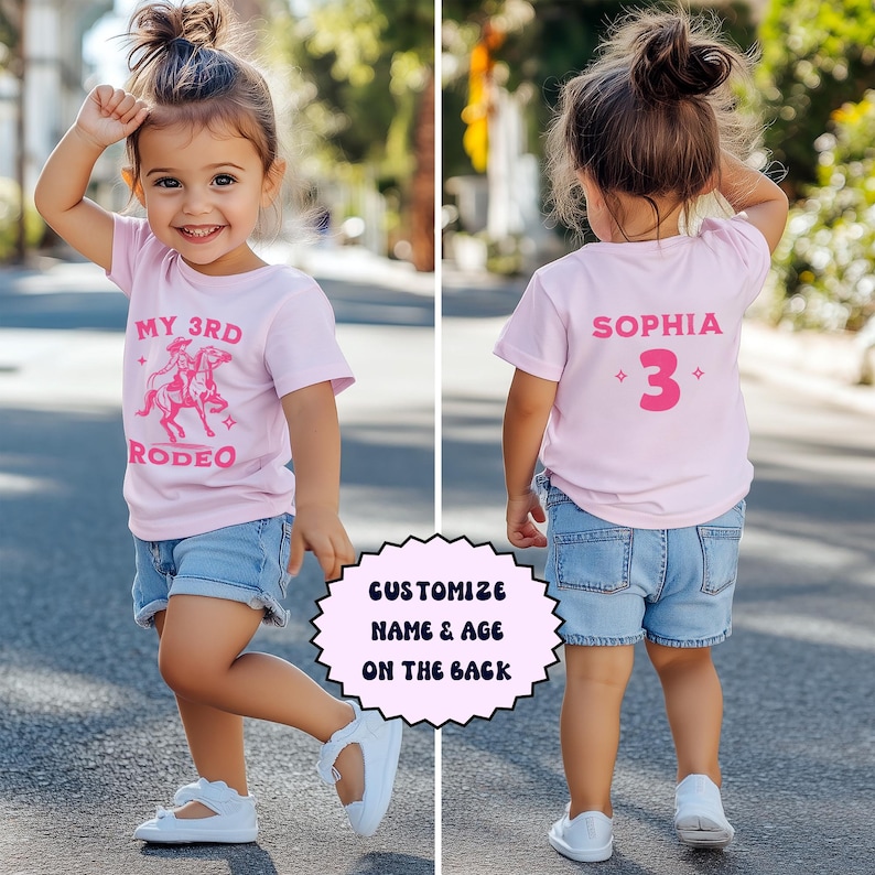 May include: Pink t-shirt with a pink graphic of a girl riding a horse and the text "My 3rd Rodeo". The back of the shirt has the text "Sophia 3" in pink.