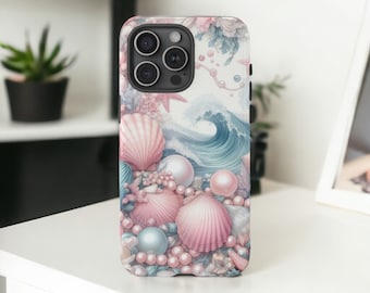 May include: A phone case featuring a seashell and pearl design. The case has a white background with a wave, pink seashells, and pearls. The case is on a white surface.