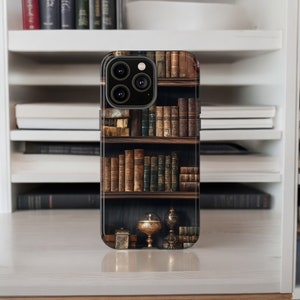 May include: A phone case featuring a design of a bookshelf filled with antique books. The case has a camera lens cutout and a dark background.
