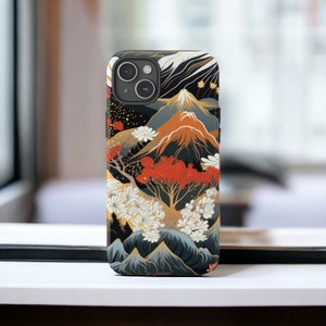 May include: A black phone case with a colourful Japanese-inspired design featuring mountains, trees, and flowers. The case has a gold accent and a camera cutout.