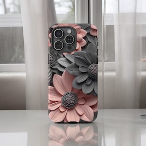 May include: A phone case with a floral design. The case features pink and gray flowers with a 3D effect. The phone case is compatible with iPhone 13 Pro.