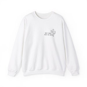 May include: White sweatshirt with a black cactus graphic and the text "Don't Dance With The Devil" printed on the front.