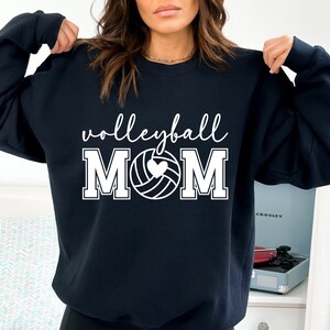 May include: Black sweatshirt with white text that reads "volleyball MOM" with a white volleyball graphic with a heart in the center.