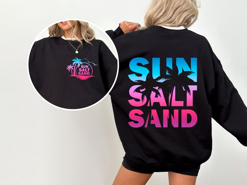 May include: Black sweatshirt with a gradient print of palm trees and the words "SUN SALT SAND" on the back. The front of the sweatshirt has a smaller version of the print on the left chest.