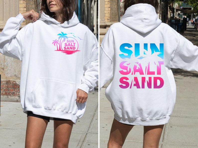 May include: White hoodie with a graphic print of palm trees and the text "SUN SALT SAND" on the front and the same text in a gradient design on the back.