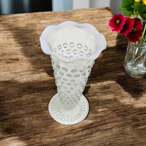 Fenton , milk glass and clear opalescent hobnail vase, 5.5 inches tall.