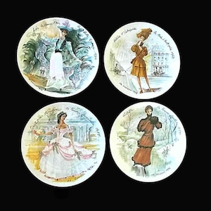 May include: Set of four decorative plates featuring vintage fashion illustrations. Each plate showcases a different woman in period attire, set against a painted background. The plates are round and have text around the edges, with a black background.