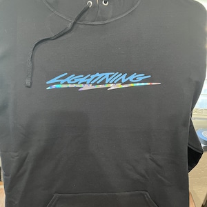 May include: Black hooded sweatshirt with a blue and iridescent lightning bolt graphic and the word "LIGHTNING" in a stylized font.