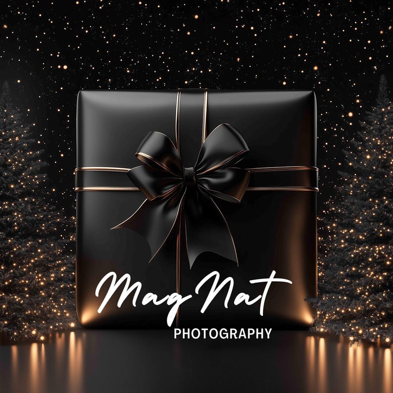 May include: A black gift box with a gold ribbon and a black bow. The box is sitting on a black surface with a starry background. The text "Mag Nat PHOTOGRAPHY" is printed on the box.