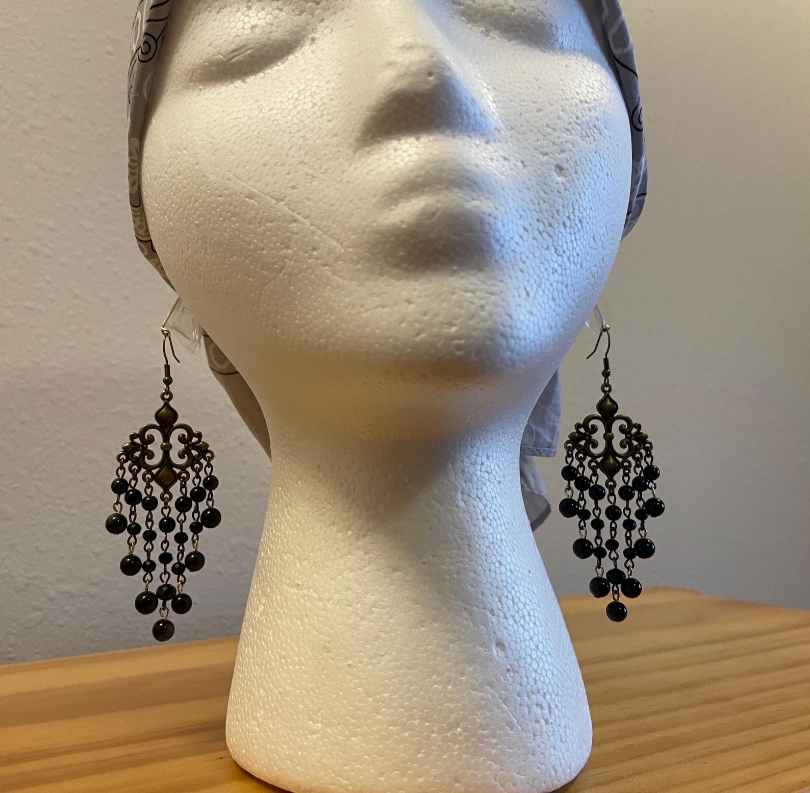 Gothic chandelier earrings displayed on mannequin head, showing elegant dangle length