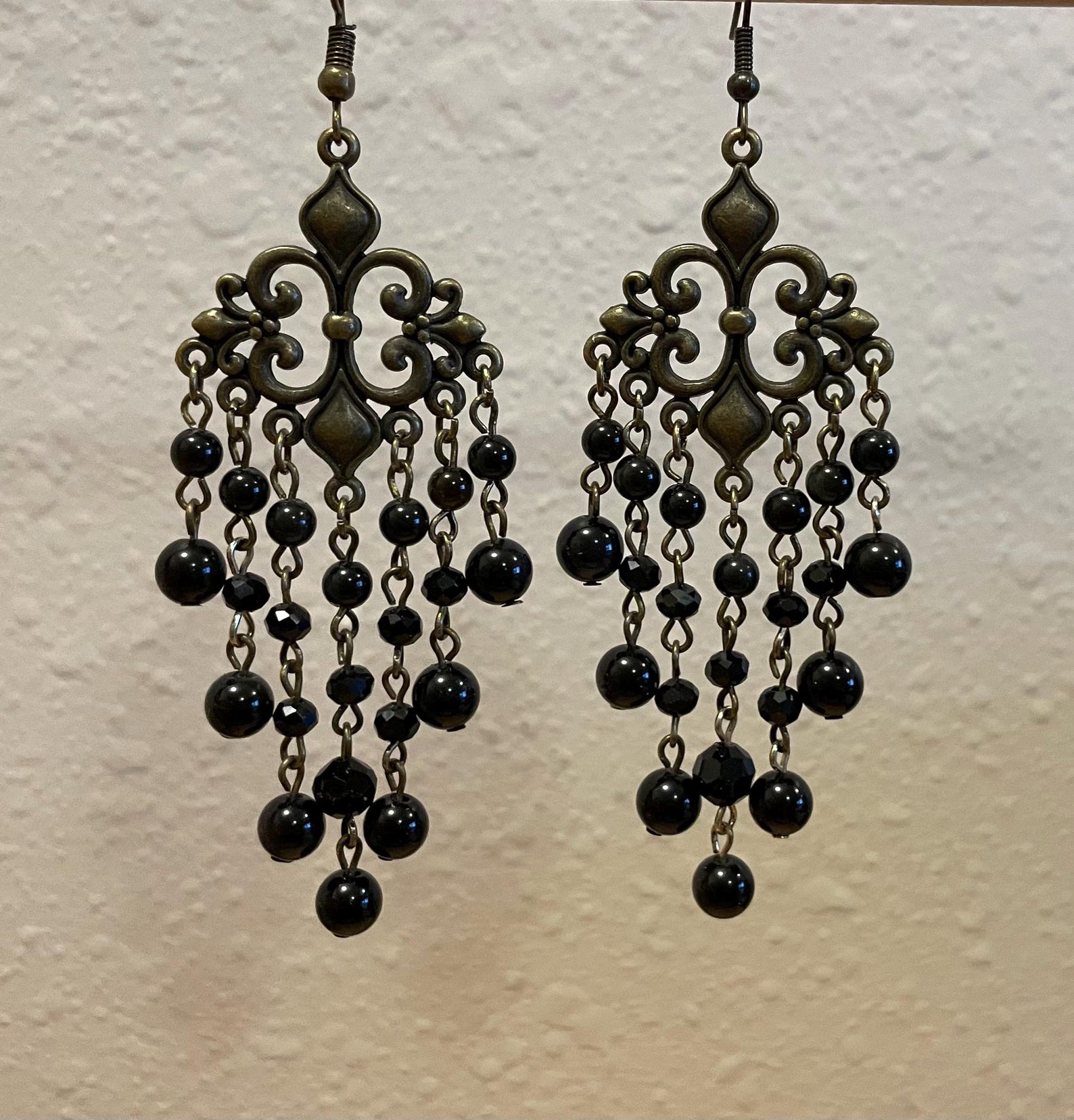 Black obsidian chandelier earrings with antique bronze filigree and cascading bead strands