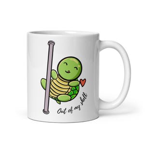 May include: White ceramic mug featuring a cartoon turtle character with a green head and shell, holding a pole. The turtle has a smiling face and a red heart. Text on the mug reads "Out of my shell."