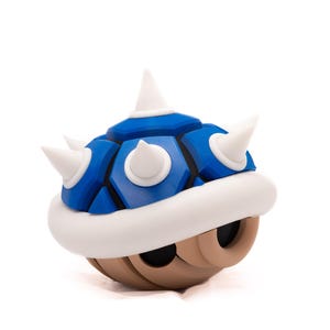 May include: A blue and white spiky shell, a popular item in the Super Mario Bros. video game series.