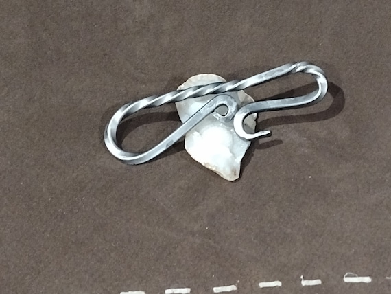 A blacksmith actually hammered and twisted raw steel into a bottle opener — it's functional sculpture you'll want to show every guest.