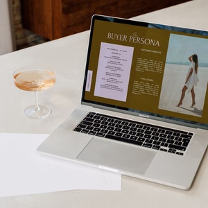 May include: A laptop computer displaying a buyer persona document with the title "The Buyer Persona". The document includes sections for customer insights and challenges. The background image is a woman walking on a beach.
