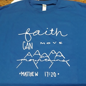 May include: A royal blue t-shirt with a white graphic that says "faith can move mountains" and "Matthew 17:20".