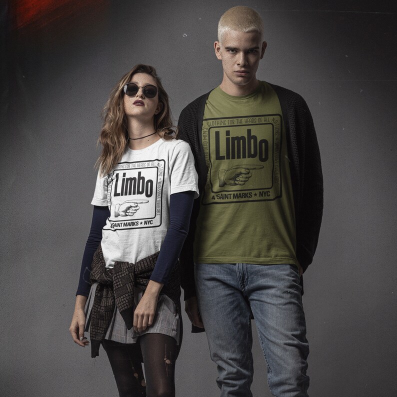 May include: Two people wearing white and green t-shirts with a black and white graphic print of a hand pointing to the right and the text "Limbo" and "A Saint Marks NYC".