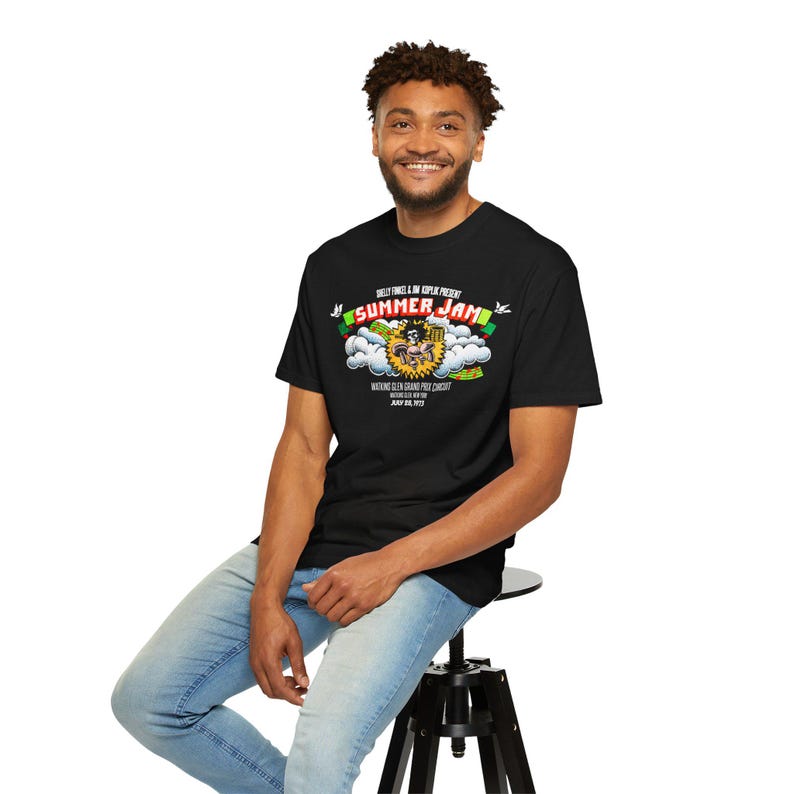 May include: A black t-shirt with a graphic print of a cartoon character in a cloud with the text "Summer Jam" and "Wu-Tang Clan Summer Jam Concert" in smaller text below.