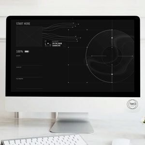 May include: A computer screen displaying a black and white design with a target in the centre. The screen also shows a progress bar that is 100% complete. The text "START HERE" is at the top of the screen. The text "I'M THE MAIN CHARACTER" is in a box on the screen. The text "TWO CIRCLE" is in a circle at the bottom right of the screen.