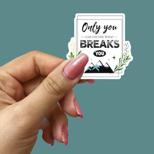 May include: White sticker with black text that reads "Only you can decide what breaks you". The sticker features a black mountain range with snow on the peaks and green foliage on the sides.