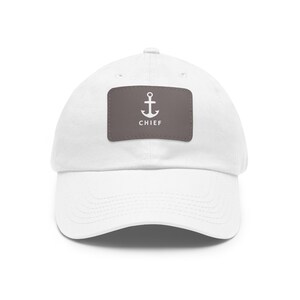 May include: White cotton baseball cap with a brown patch featuring a white anchor and the word "CHIEF" in white.