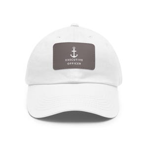 May include: White cotton baseball cap with a brown patch featuring a white anchor and the text "Executive Officer".