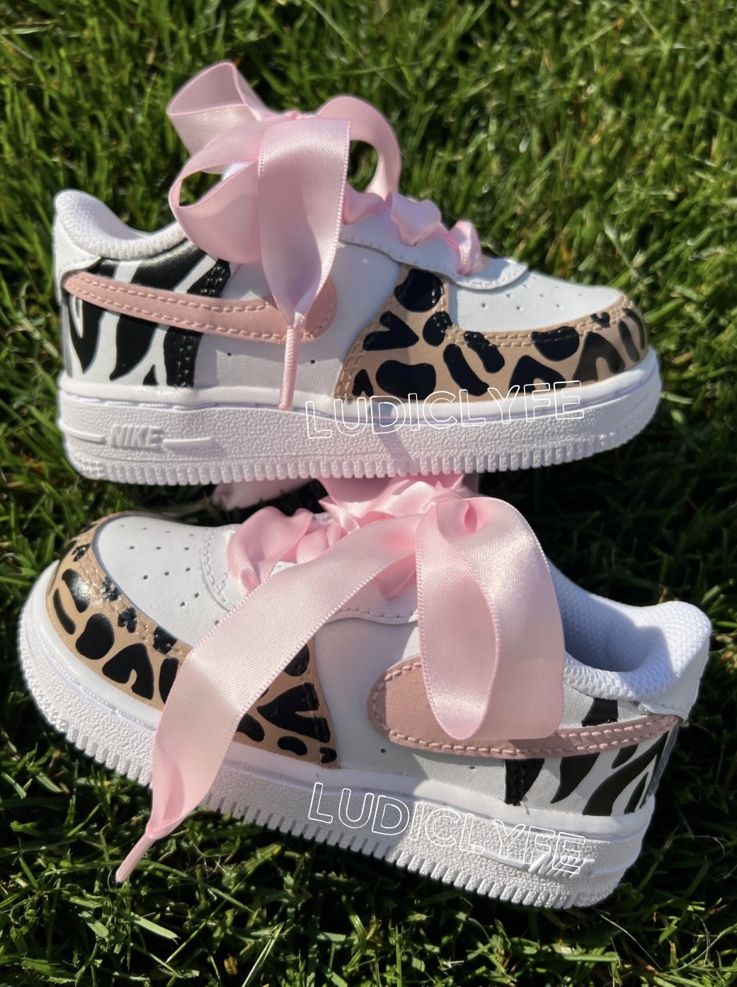 1 reimagined collection- Millennial pink Air Force ones with matching  ribbon laces. Not seen: …