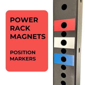 May include: Red, white, and blue power rack magnets for marking positions on a weight rack. The magnets are labeled "POWER RACK MAGNETS POSITION MARKERS".