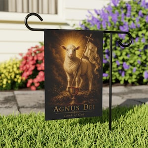 May include: A rectangular garden flag featuring a central illustration of a white lamb with a golden halo, holding a cross-topped banner and standing above a golden chalice. The text Agnus Dei and Lamb of God is printed in gold at the bottom.
