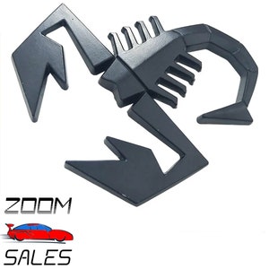 May include: Black metal scorpion emblem. The scorpion is stylised with a raised, detailed design.