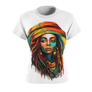 May include: A white t-shirt featuring a colourful illustration of a woman with long dreadlocks wearing a patterned head wrap. The woman's face is painted in shades of blue, green, and orange.